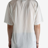 White shirt worn by a person, showing the shirt's fit