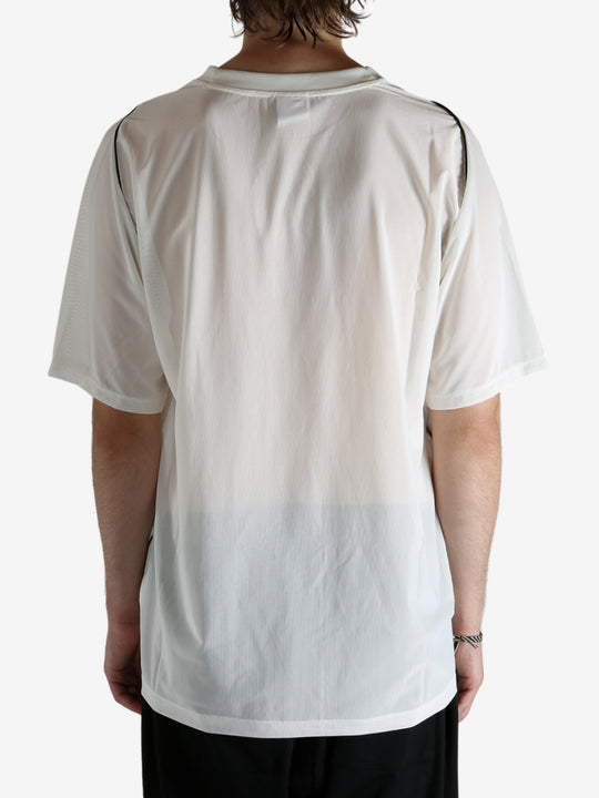 White shirt worn by a person, showing the shirt's fit
