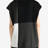 Black top worn by a person, showing the top fit