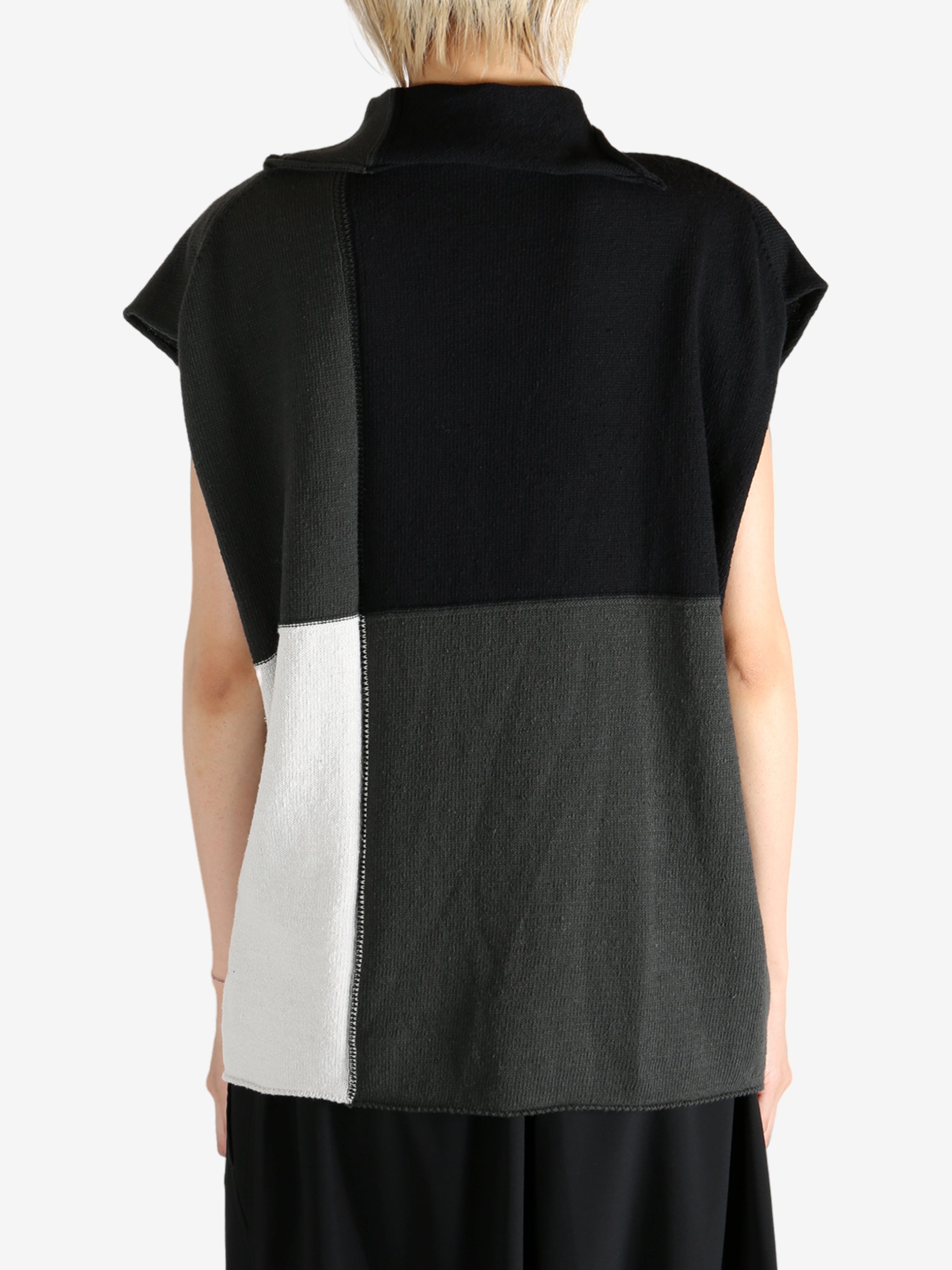 Black top worn by a person, showing the top fit