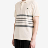 Tan shirt worn by a person, showing the shirt fit