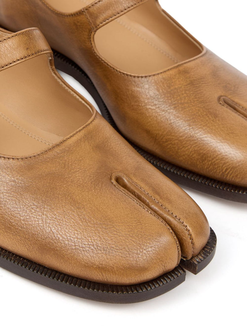 Close up of tan shoes, showing texture of calf leather fabric