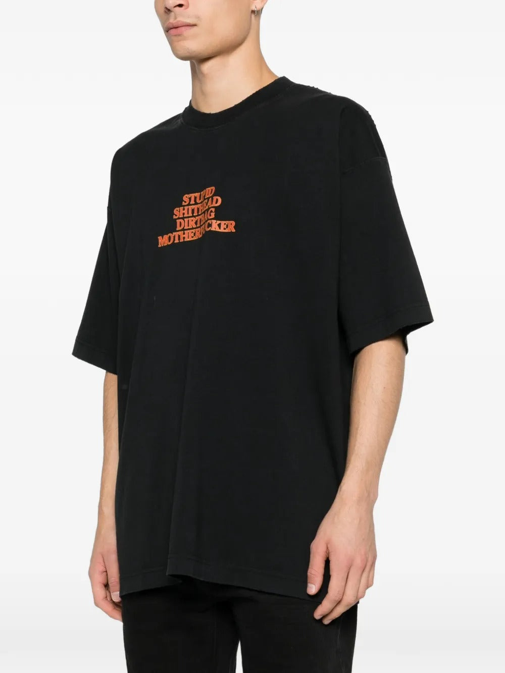 Black t-shirts worn by a person, showing the t-shirts fit