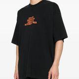 Black t-shirts worn by a person, showing the t-shirts fit