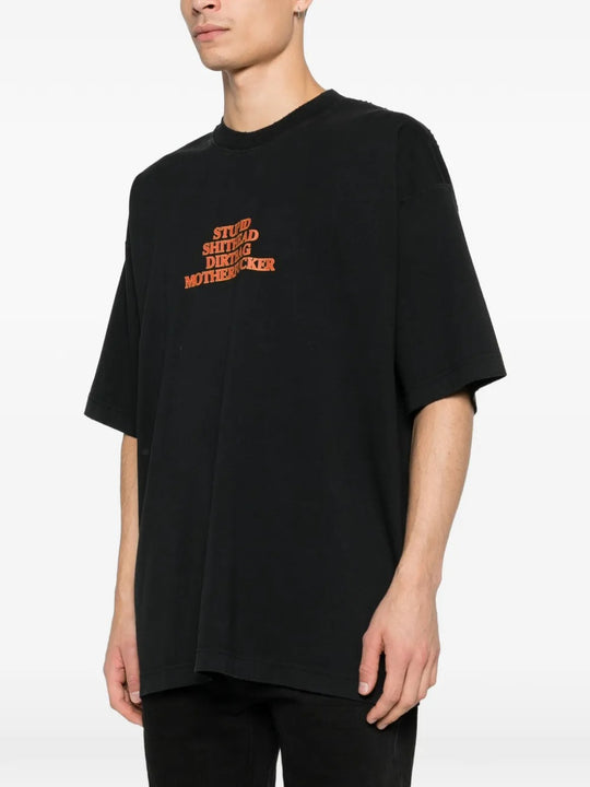 Black t-shirts worn by a person, showing the t-shirts fit