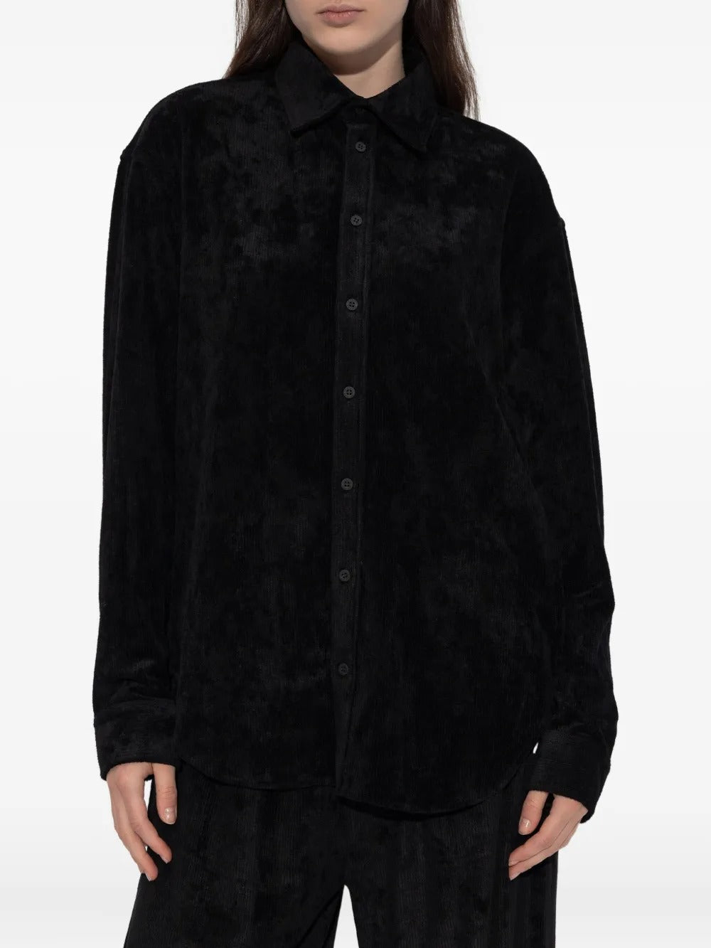 Black shirt worn by a person, showing the shirt's fit