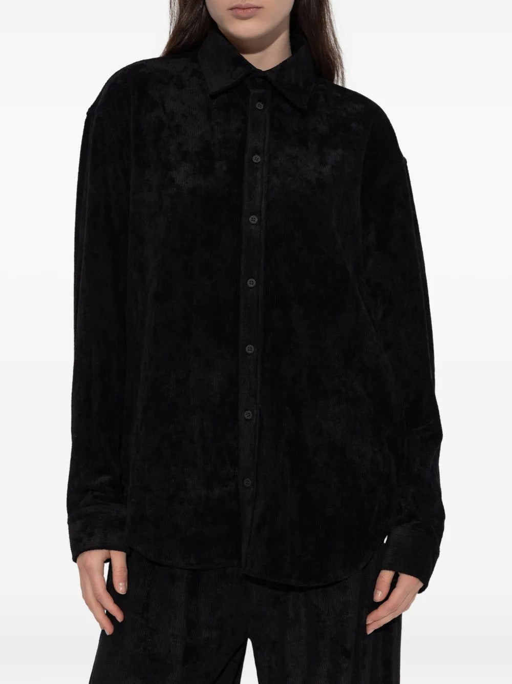 Black shirt worn by a person, showing the shirt's fit