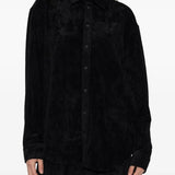 Black shirt worn by a person, showing the shirt's fit