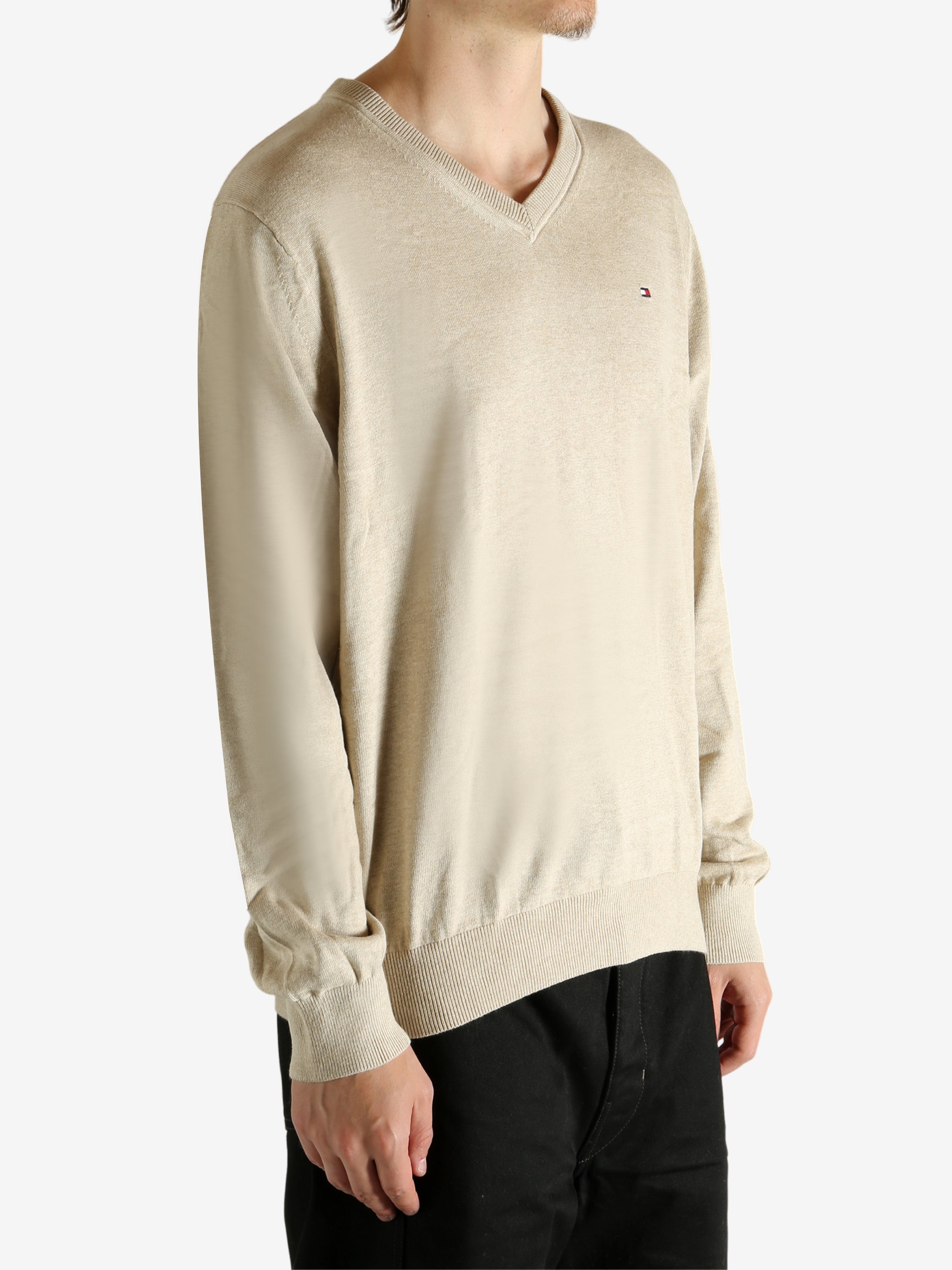 Tan shirt worn by a person, showing the shirt's fit