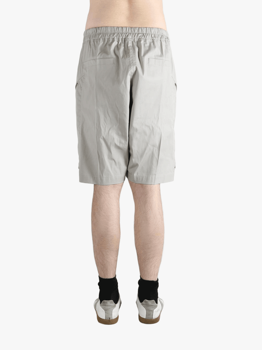 Grey shorts worn by a person, showing the shorts fit