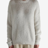 White top worn by a person, showing the top fit