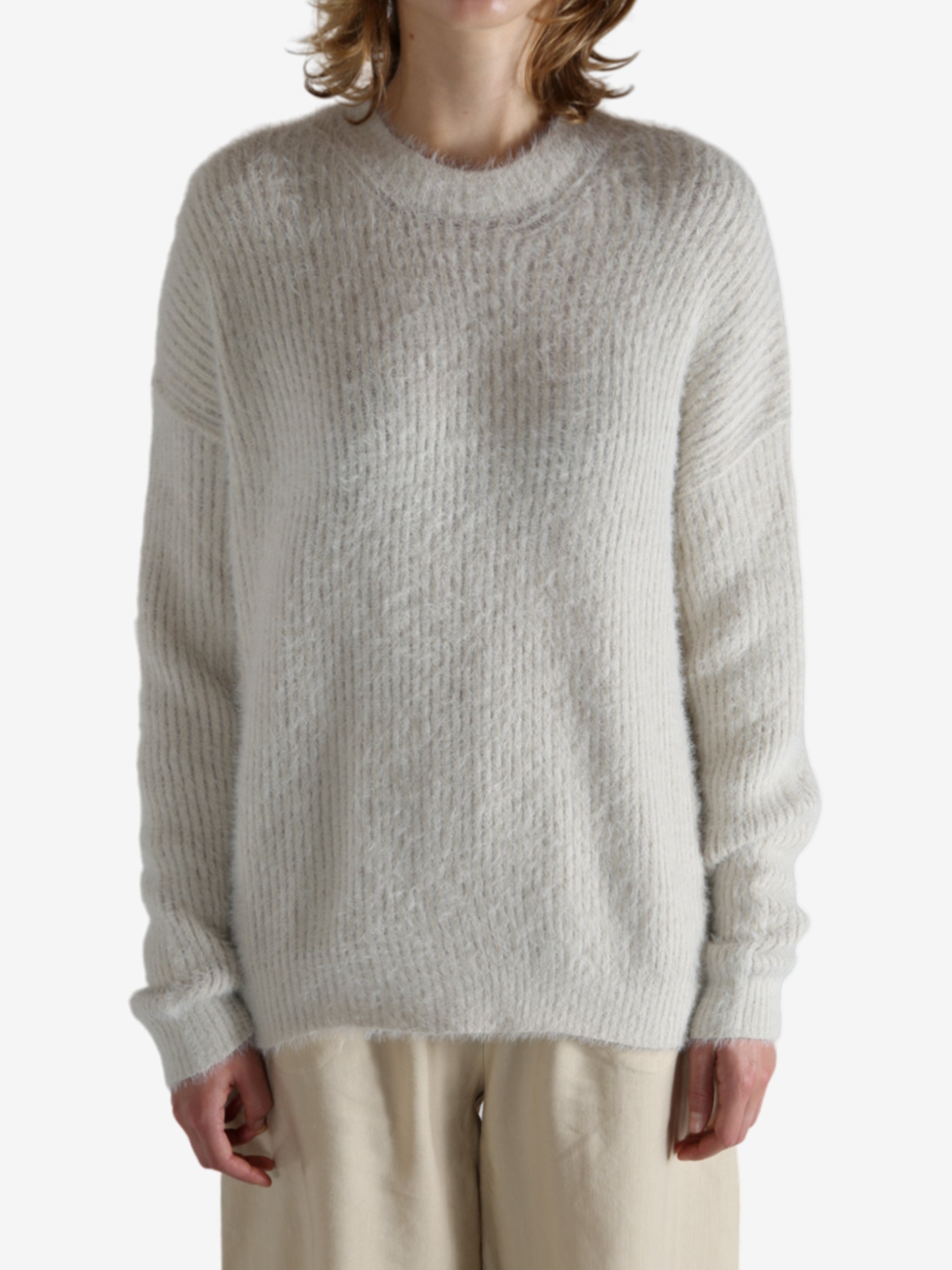 White top worn by a person, showing the top fit