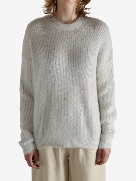 White top worn by a person, showing the top fit