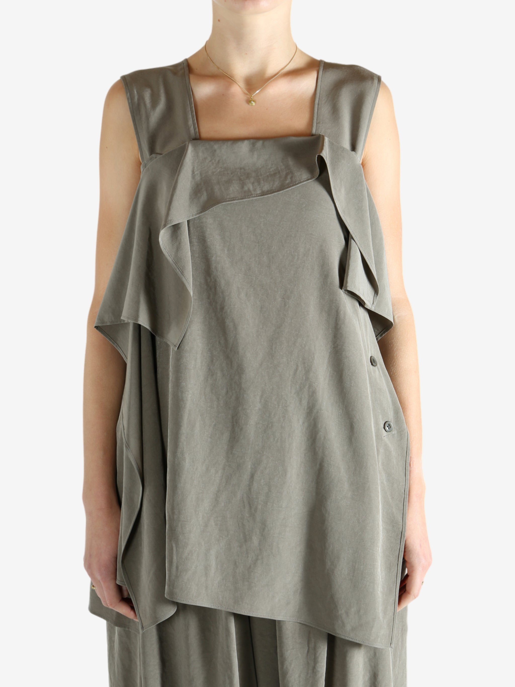 Grey tops worn by a person, showing the tops fit