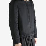 Black jacket worn by a person, showing the jacket fit