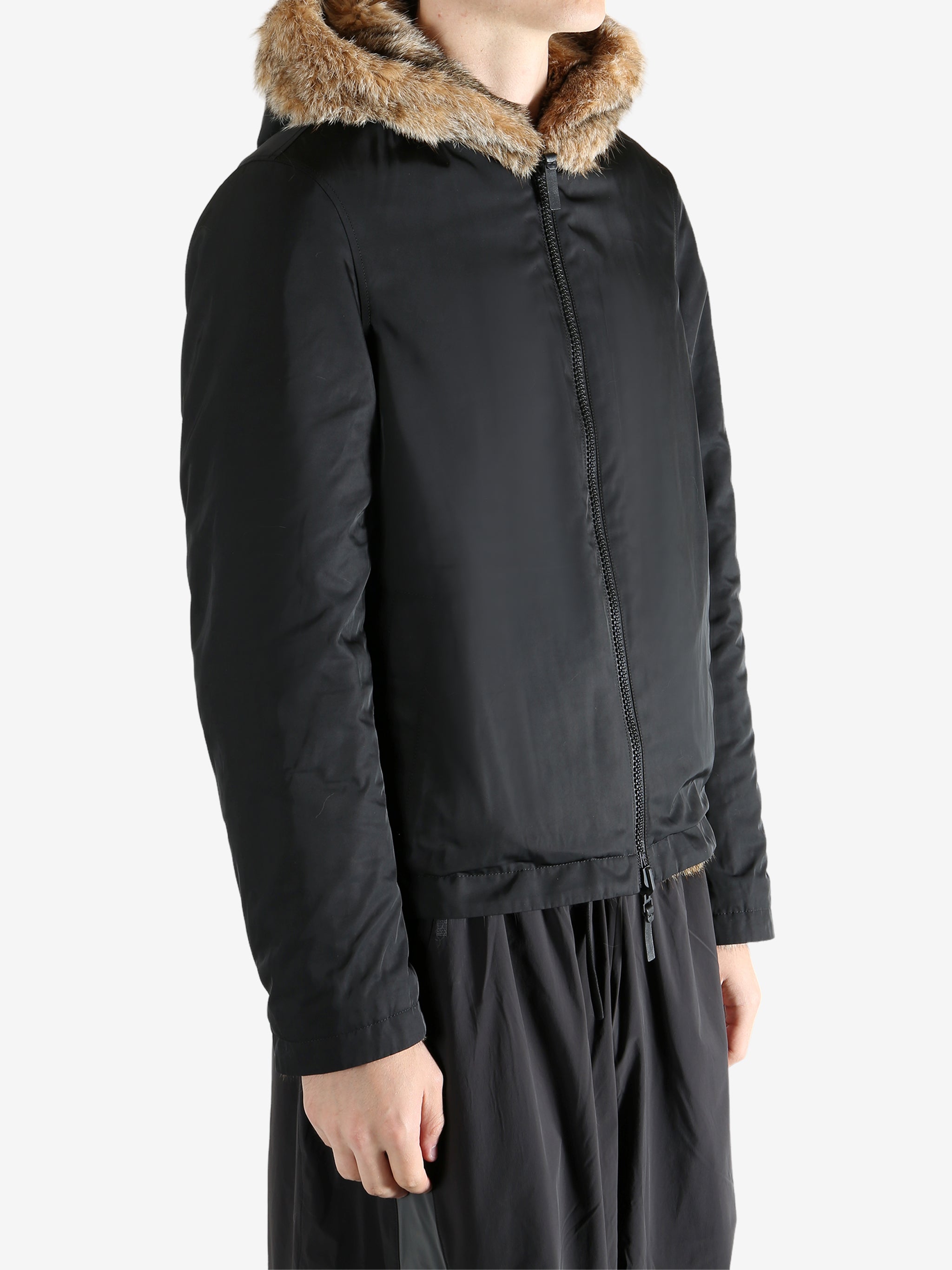 Black jacket worn by a person, showing the jacket fit