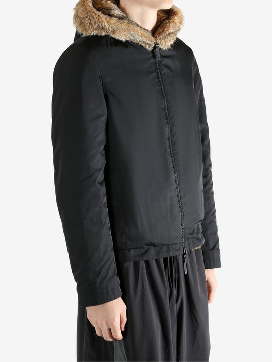 Black jacket worn by a person, showing the jacket fit