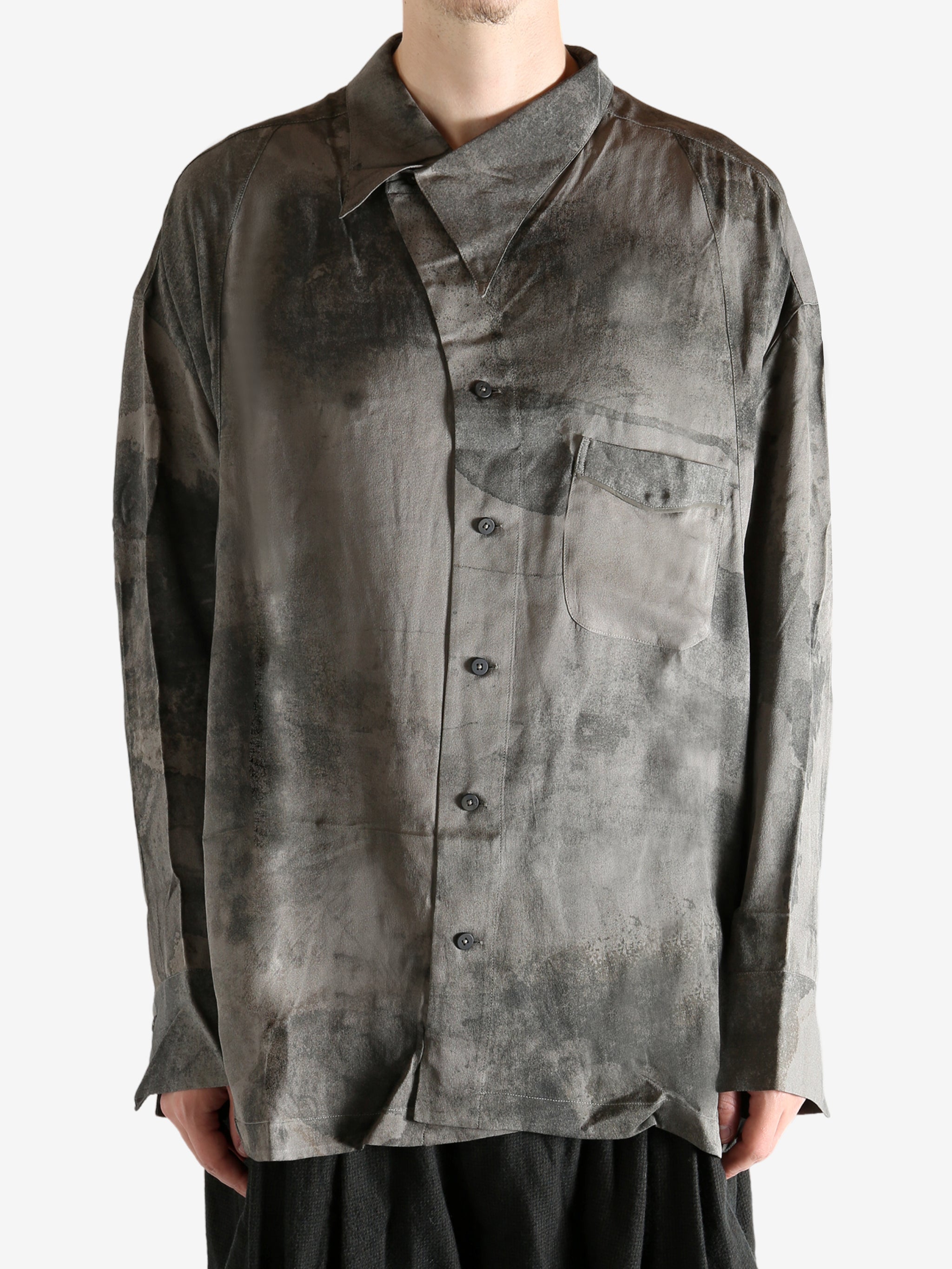 Grey shirt worn by a person, showing the shirt's it