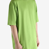 Green t-shirt worn by a person, showing the shirt's fit