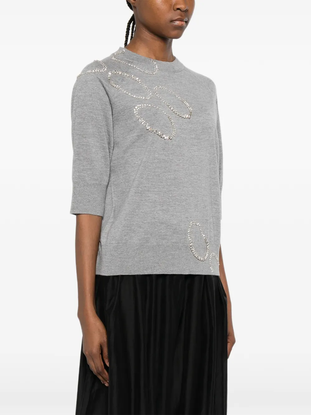 Grey sweater worn by a person, showing the sweater's fit