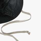 Close up of black hats, showing texture of the fabric