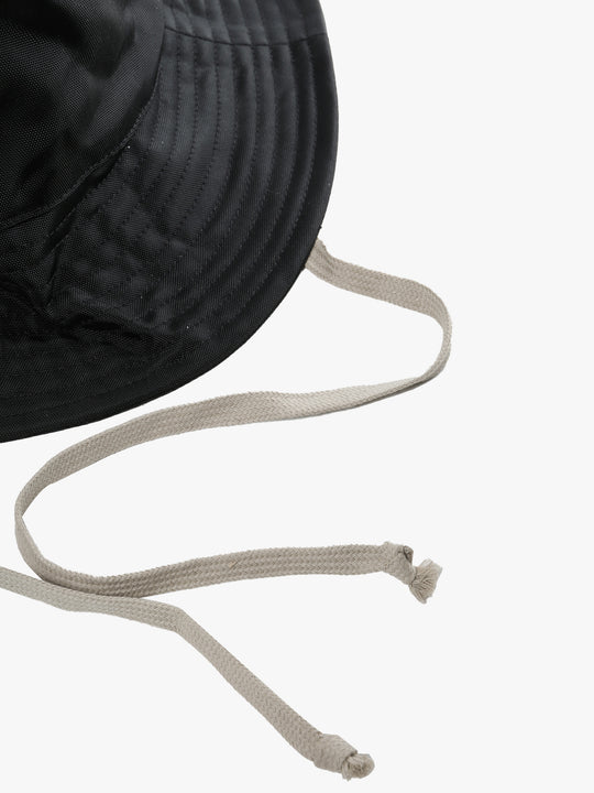 Close up of black hats, showing texture of the fabric