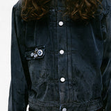 Close up of the grey jacket, showing texture of the cotton fabric