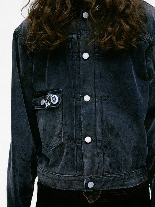 Close up of the grey jacket, showing texture of the cotton fabric