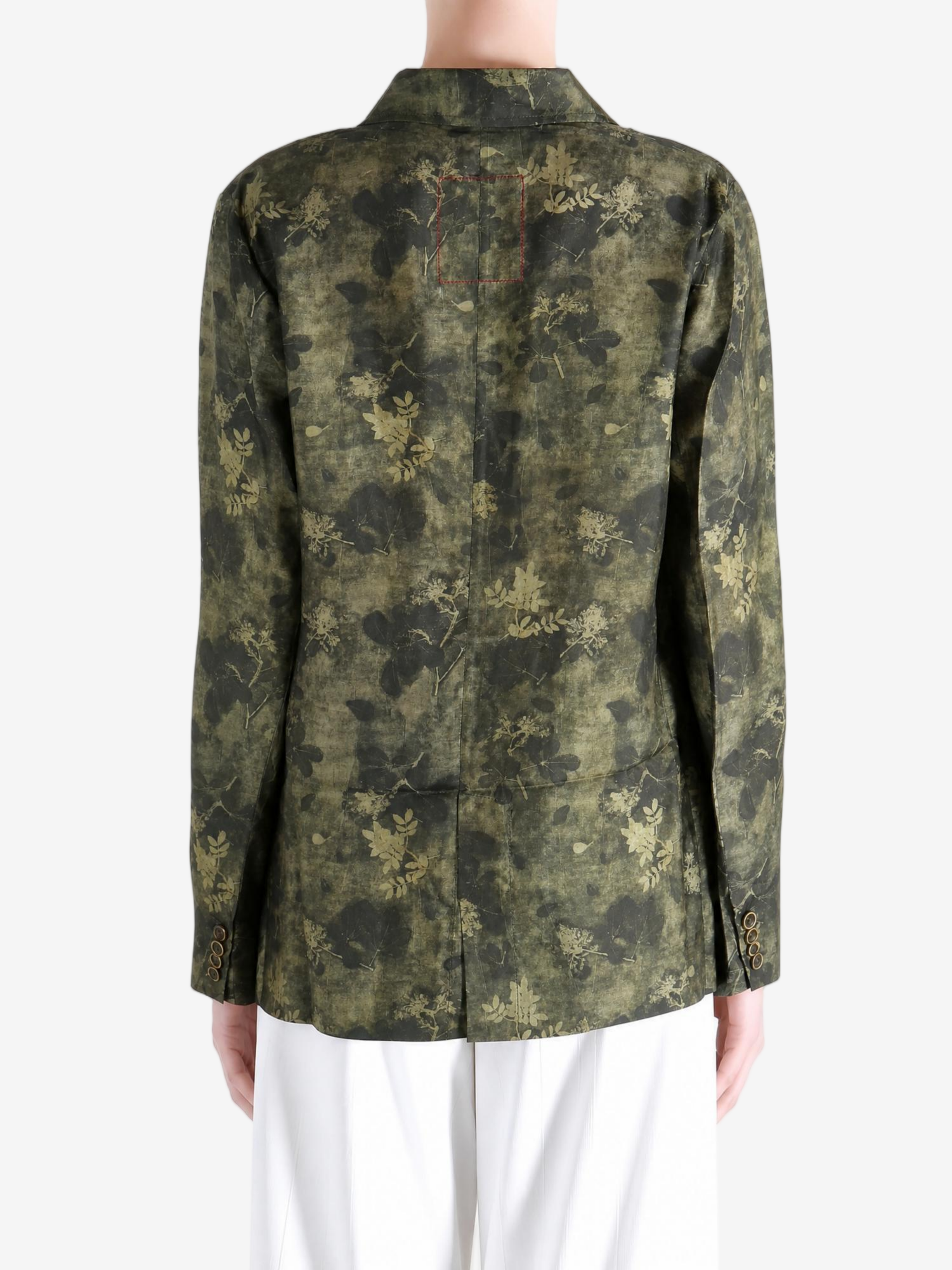 Green jacket worn by a person, showing the jacket fit