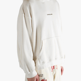 White hoodie worn by a person, showing the hoodie's fit