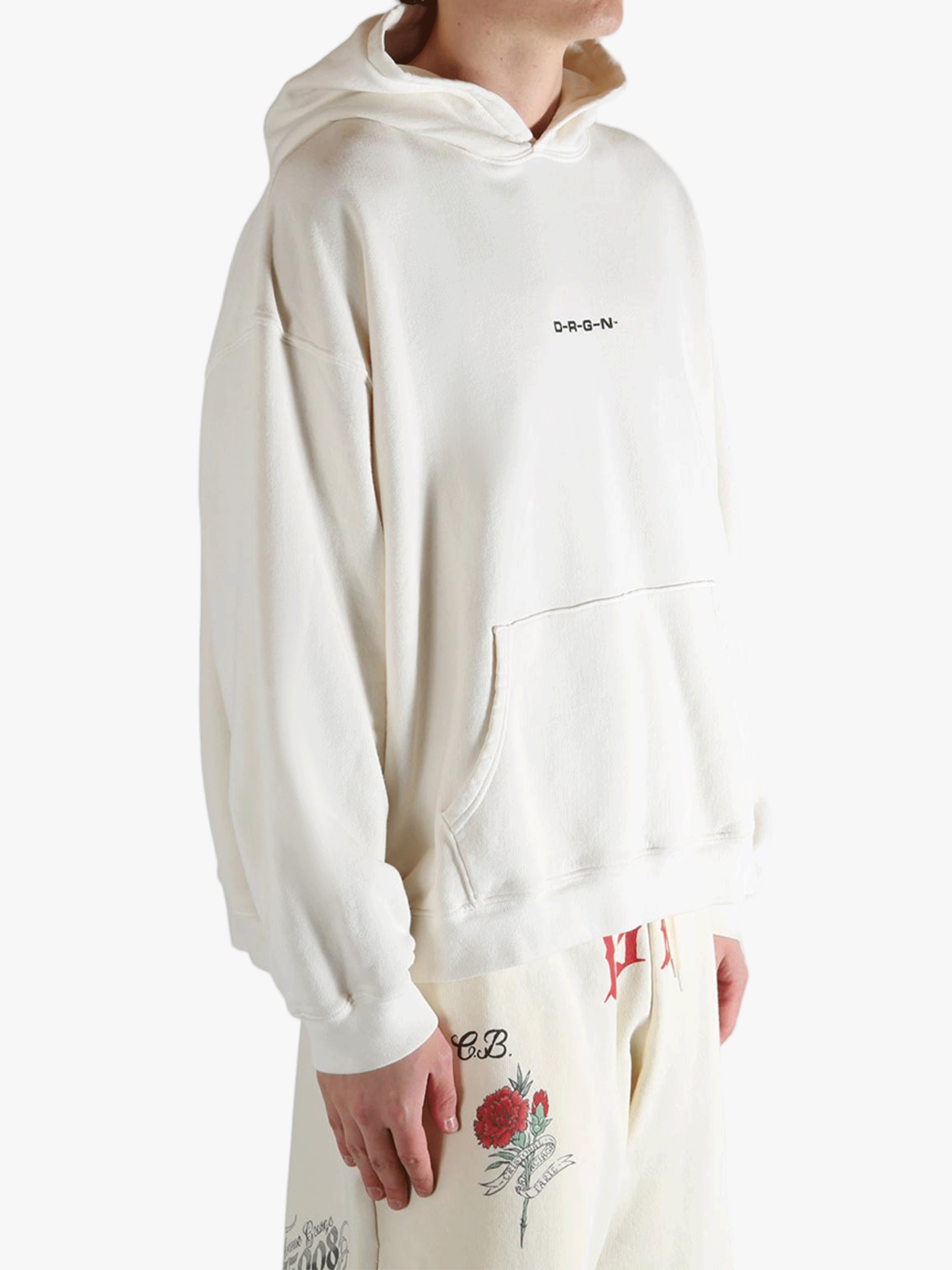 White hoodie worn by a person, showing the hoodie's fit