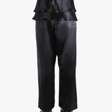 Black pants worn by a person, showing the pants' fit