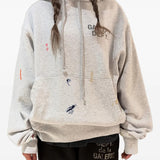 Grey hoodie worn by a person, showing the hoodie's fit
