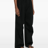 Black pants worn by a person, showing the pants 's fit