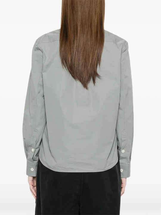 Gray button-up shirt worn by a person, showing the shirt's fit