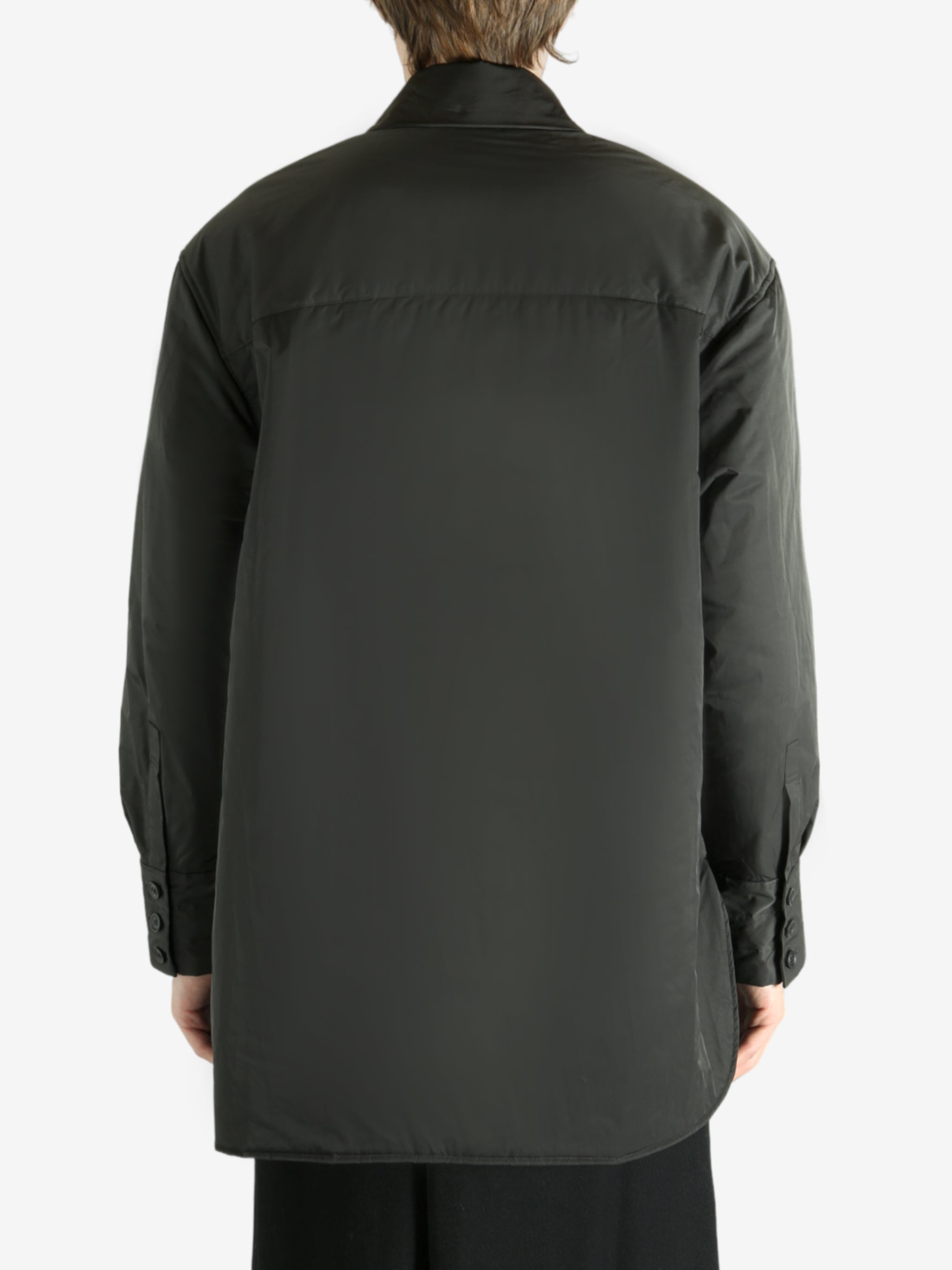 Black coat worn by a person, showing the coat's fit