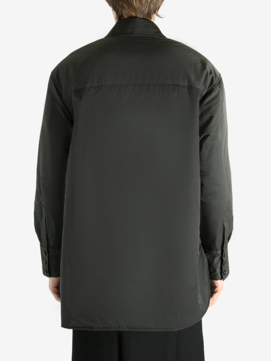 Black coat worn by a person, showing the coat's fit