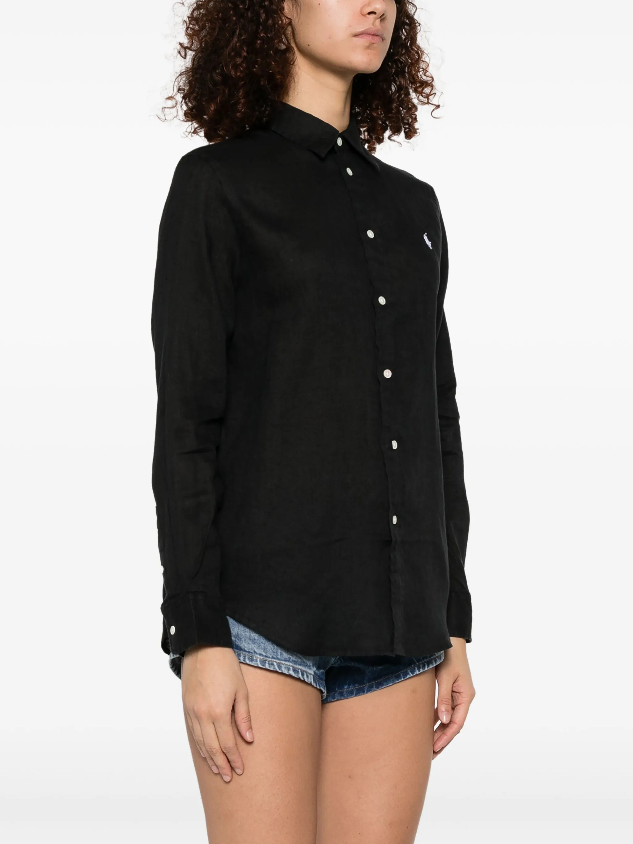 black shirt worn by a person, showing the shirt's fit