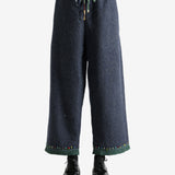 Navy pants worn by a person, showing the pants's fit