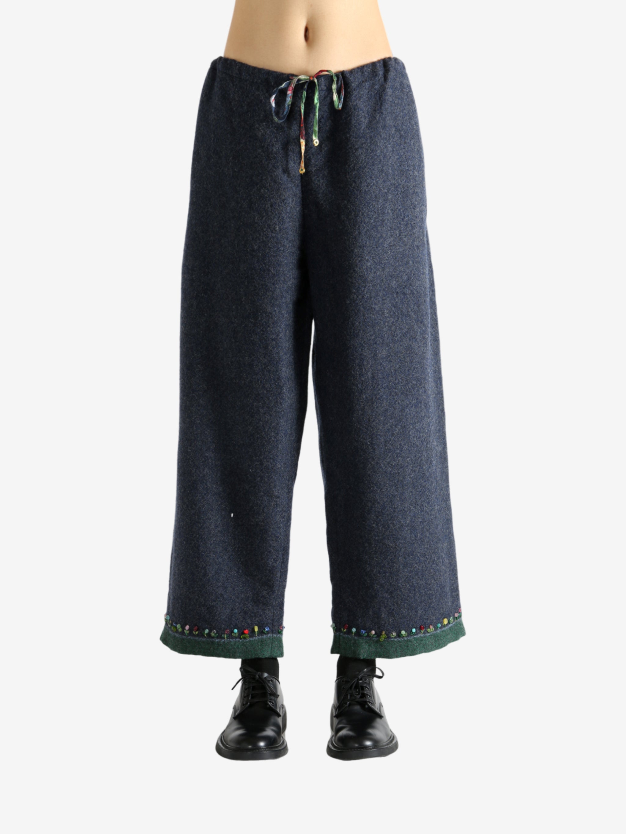 Navy pants worn by a person, showing the pants's fit