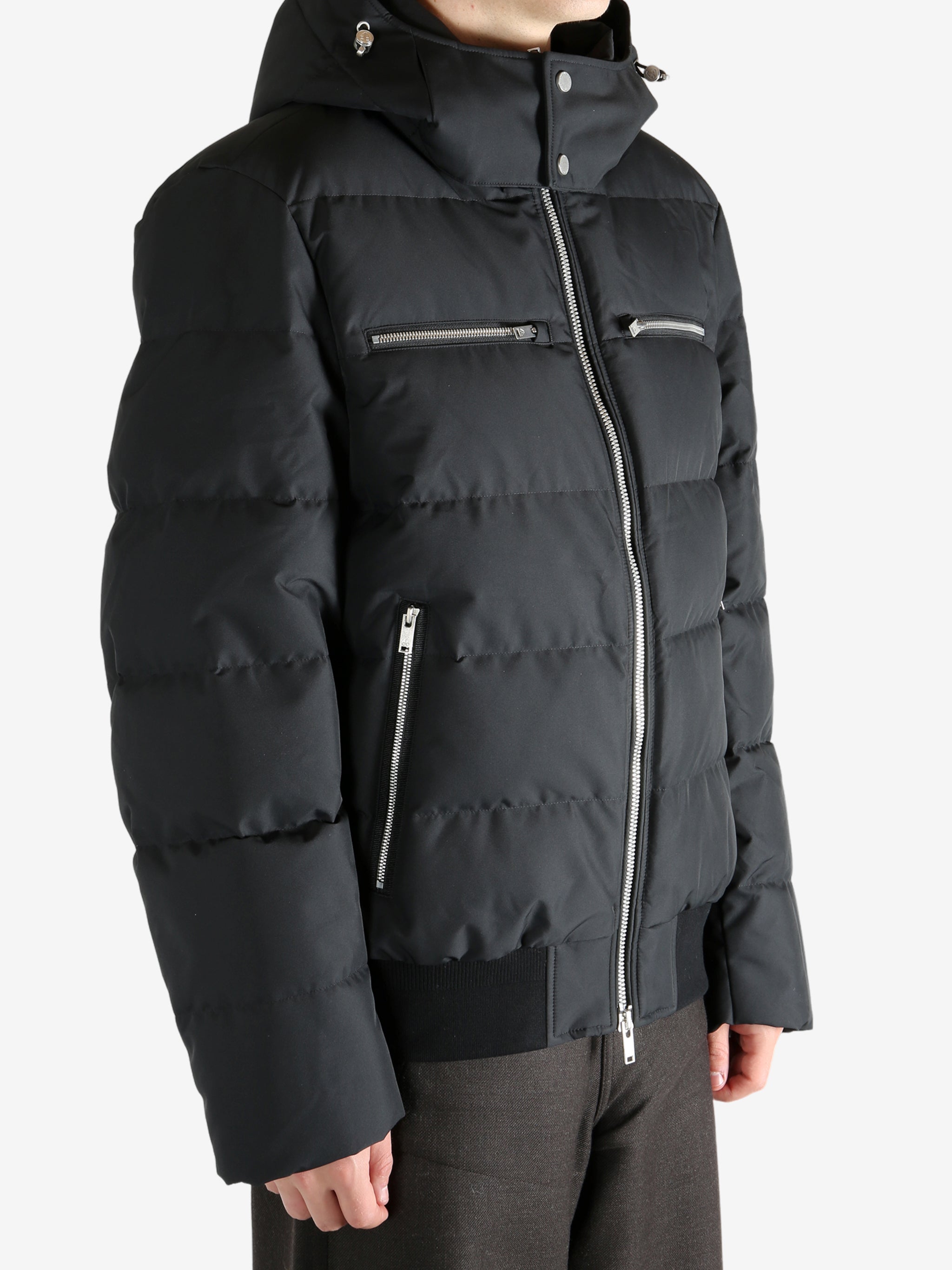 Black coat worn by a person, showing the coat's fit