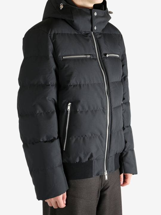 Black coat worn by a person, showing the coat's fit