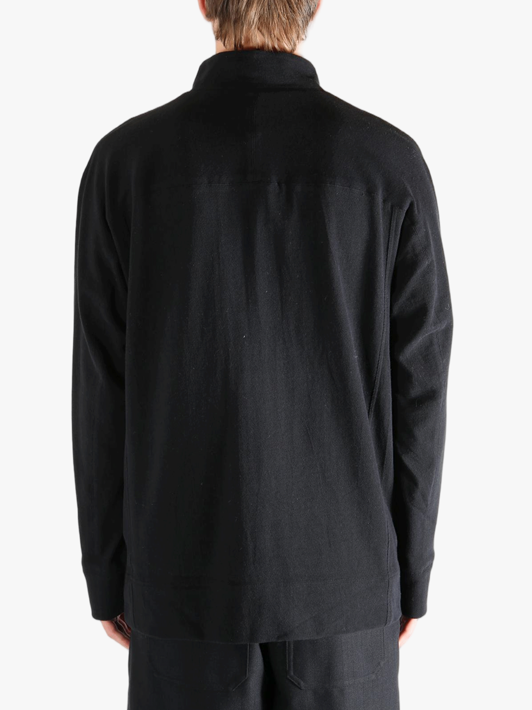 Black jacket worn by a person, showing jacket's fit