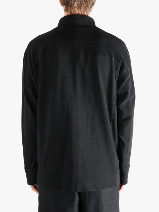 Black jacket worn by a person, showing jacket's fit