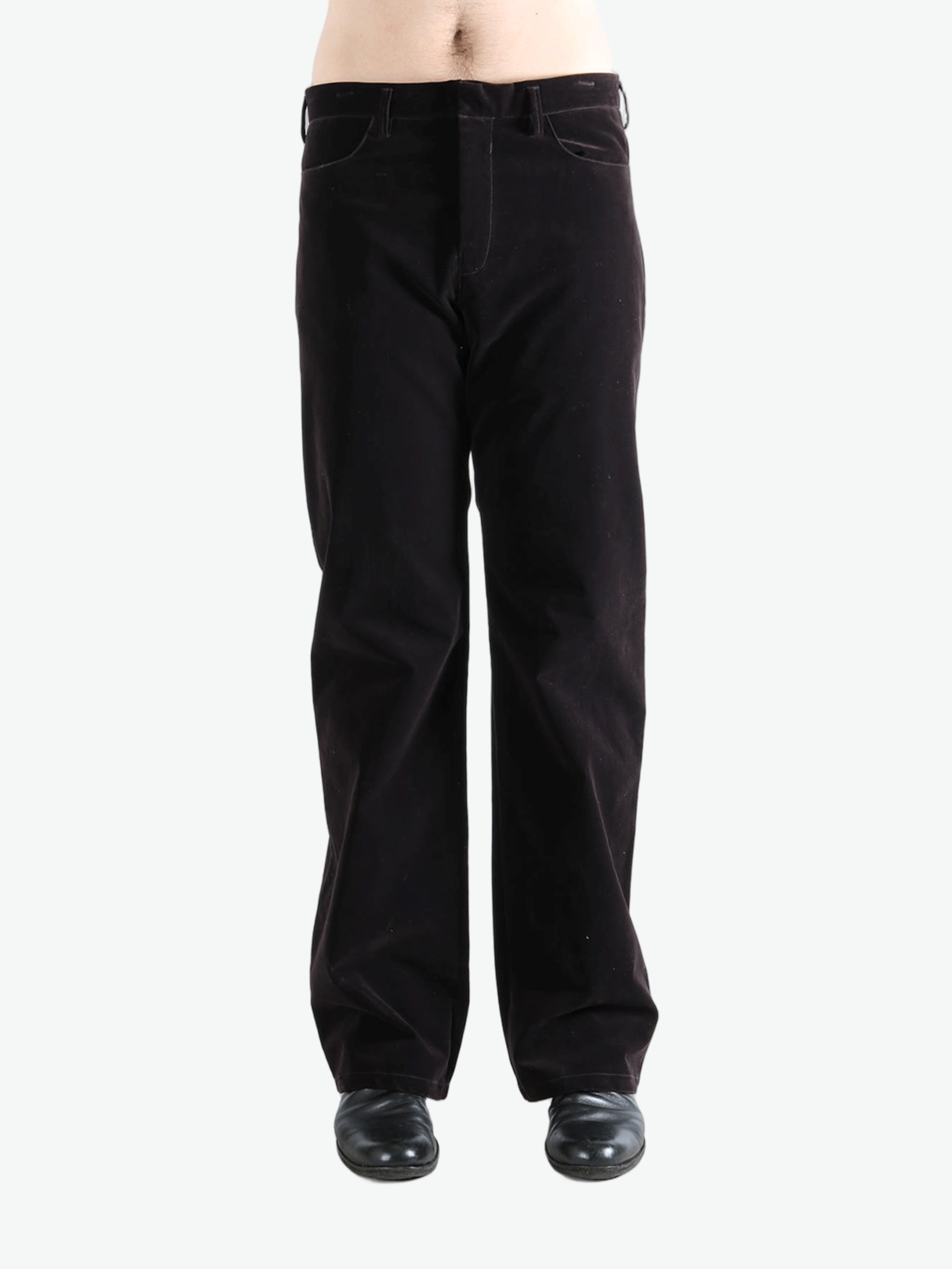 Black pants worn by a person, showing the pants  fit