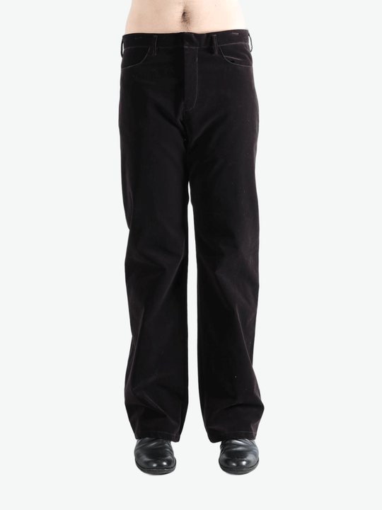 Black pants worn by a person, showing the pants  fit