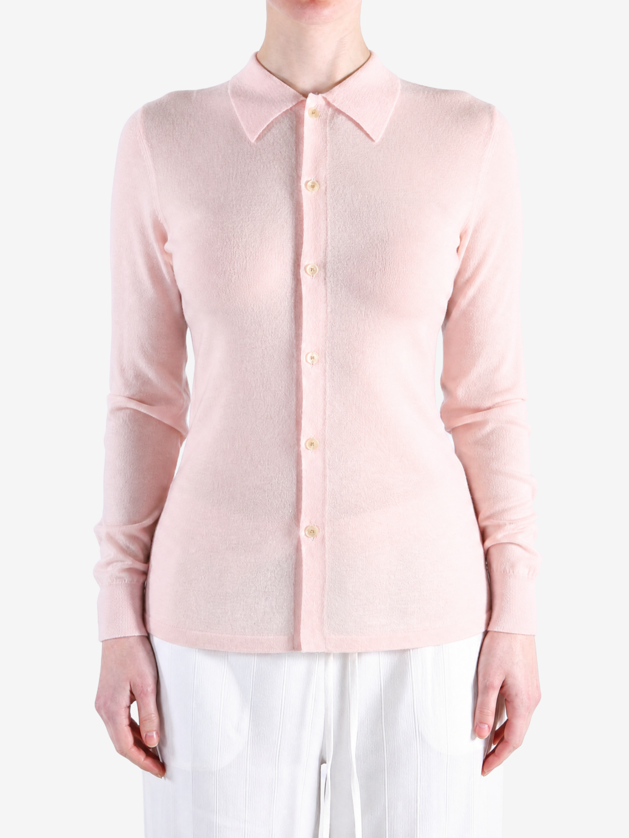 Pink knitwear worn by a person, showing the knitwear fit