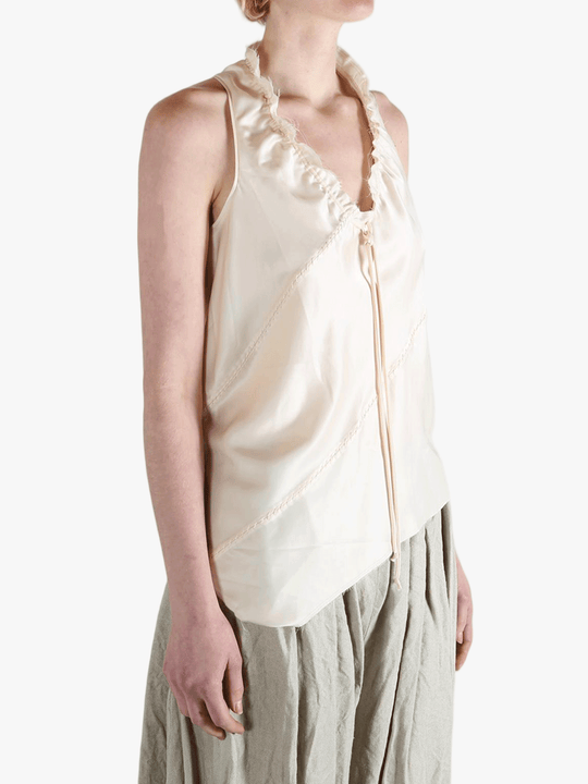 White top worn by a person, showing the top's fit