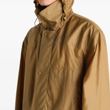 Close up of brown jacket, showing texture of the nylon fabric