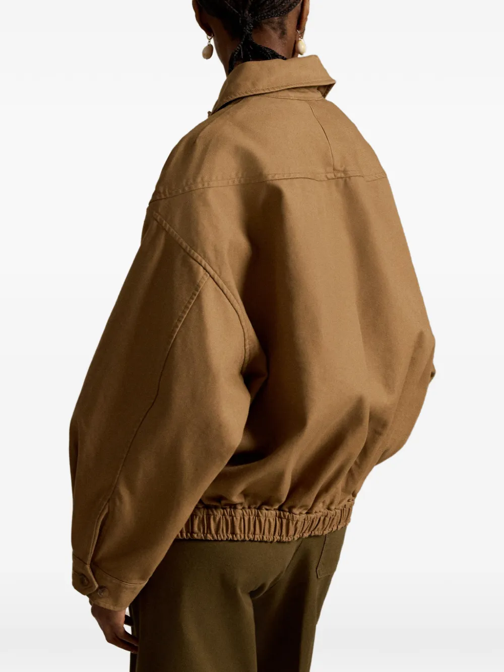 Brown jacket worn by a person, showing the jacket's fit